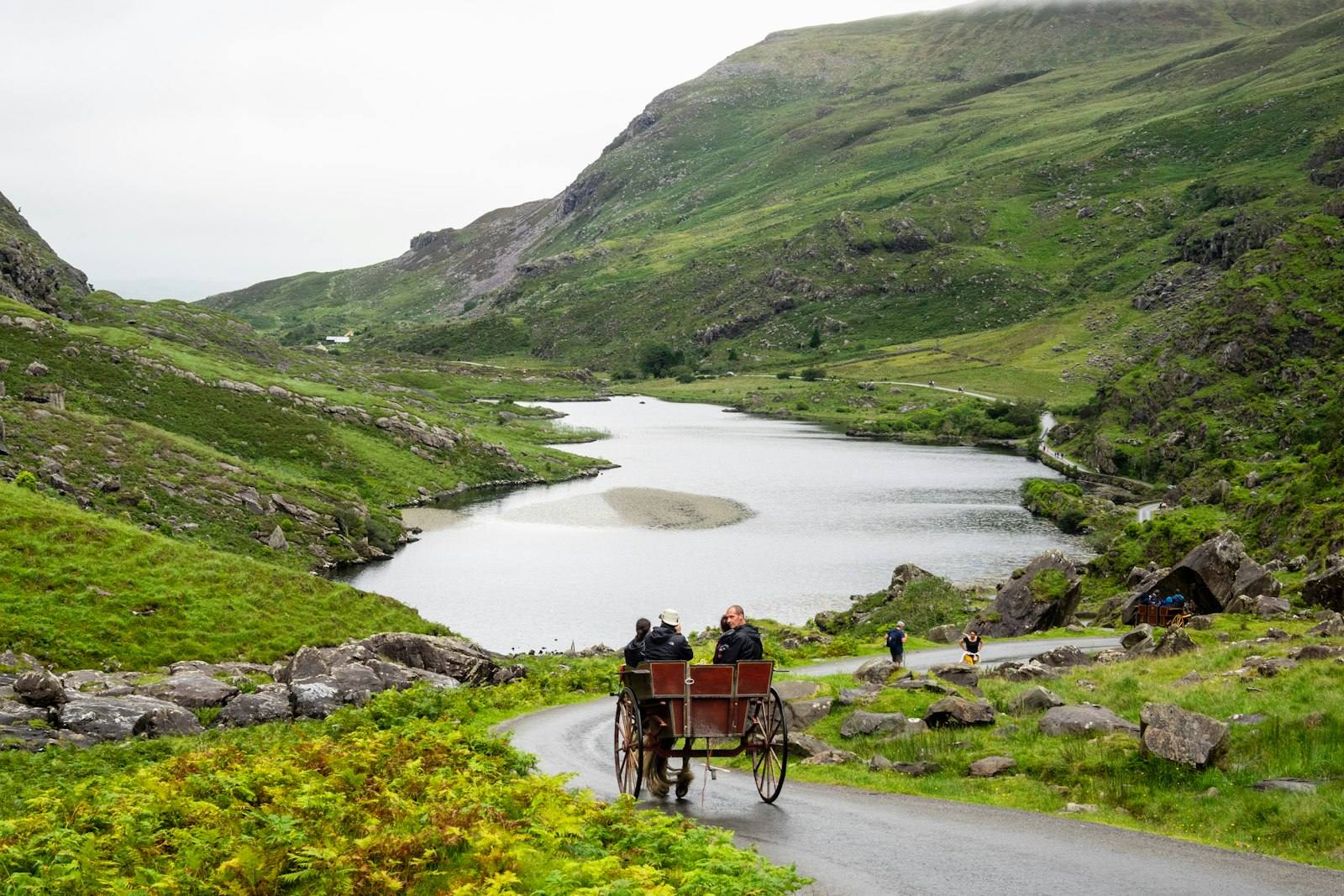 Visitors in a pony and trap descending through the Gap of Dunloe toward Augher Lake, County Kerry