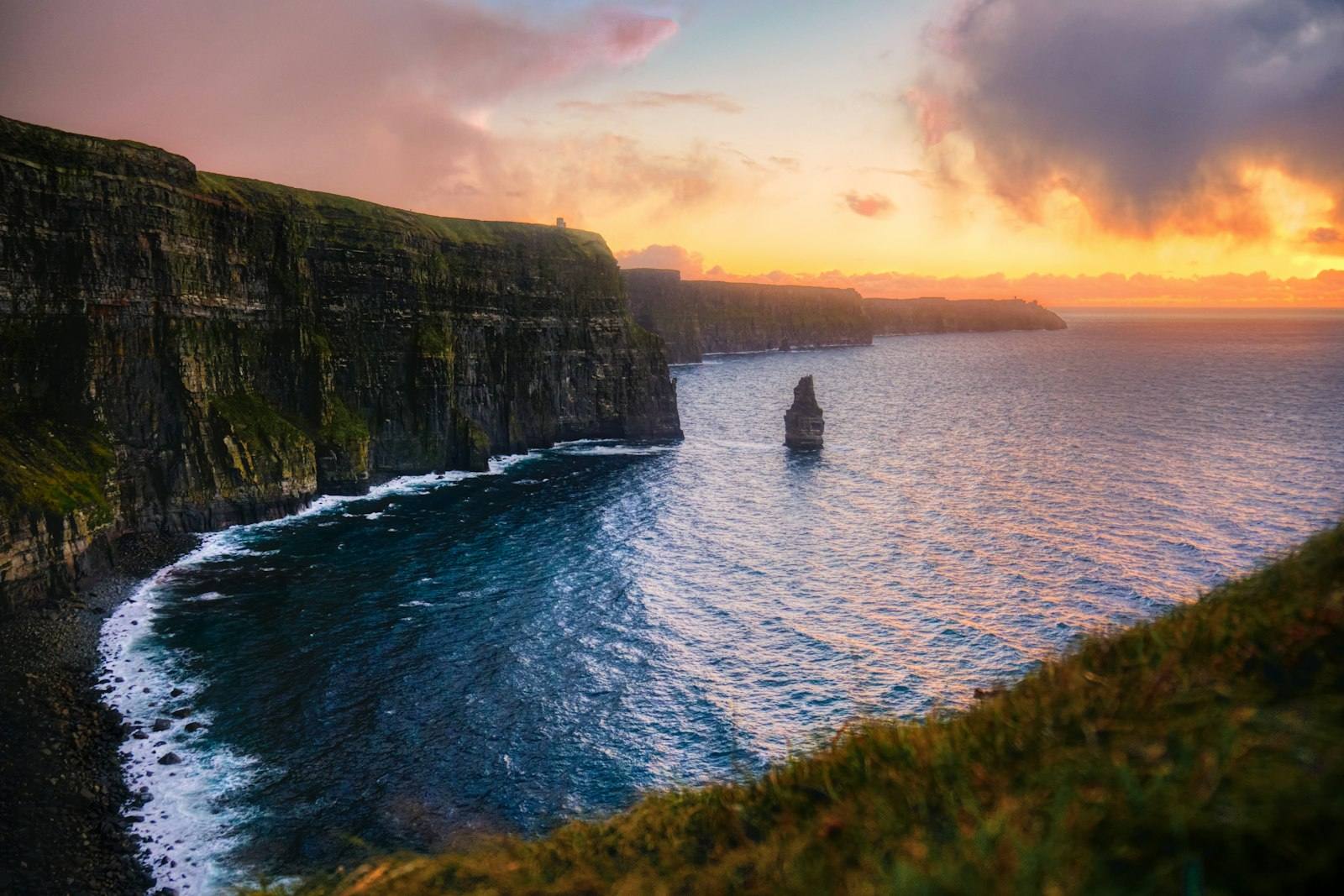 The Cliffs of Moher and Branaunmore sea stack at sunset, County Clare